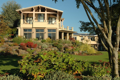 Inspiration for a huge contemporary beige two-story stucco gable roof remodel in Seattle
