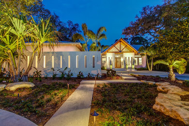Photo of a large contemporary one-storey stucco exterior in Tampa with a gable roof.