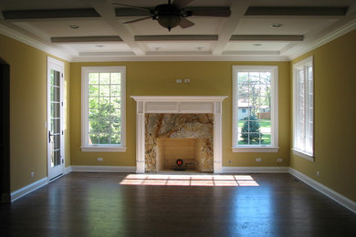 Family room - mid-sized traditional enclosed dark wood floor family room idea in Chicago with yellow walls, a standard fireplace and a tile fireplace