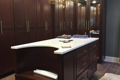 Dressing room - large traditional gender-neutral dark wood floor and brown floor dressing room idea with shaker cabinets and dark wood cabinets