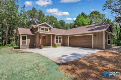 Example of a large mountain style brown one-story vinyl exterior home design in Other with a shingle roof
