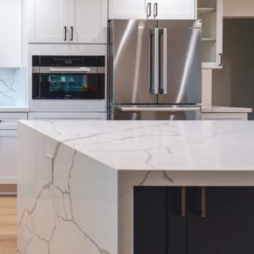 Modern White Shaker Kitchen with Navy Blue Island and Waterfall Quartz Counterto