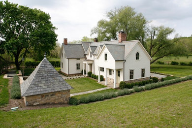 Large farmhouse white two-story concrete fiberboard exterior home idea in New York with a hip roof