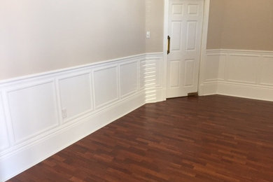 Inspiration for a mid-sized timeless formal and enclosed dark wood floor and brown floor living room remodel in New Orleans with beige walls, no fireplace and no tv