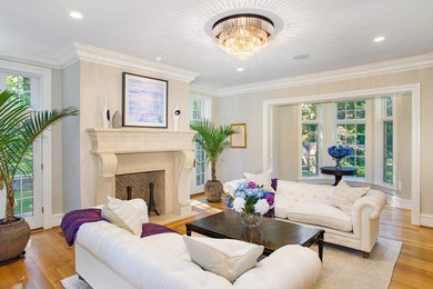 Inspiration for a mid-sized transitional formal and open concept light wood floor living room remodel in Philadelphia with beige walls, a standard fireplace and no tv