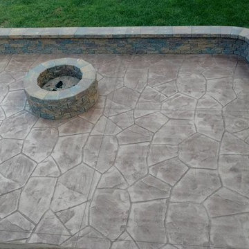 Stamped concrete patio with block seating wall and block fire-pit