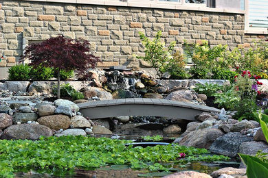 Photo of a large traditional full sun backyard brick landscaping in Toronto for summer.