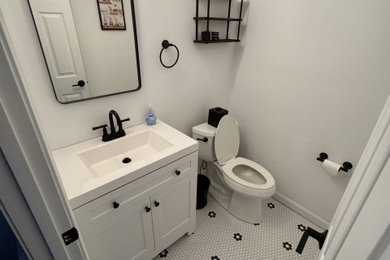 Small farmhouse ceramic tile, white floor and single-sink bathroom photo in Boston with shaker cabinets, white cabinets, a two-piece toilet, blue walls, an integrated sink, quartz countertops, white countertops and a freestanding vanity