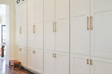 Large transitional medium tone wood floor and brown floor built-in closet photo in Dallas with shaker cabinets and white cabinets