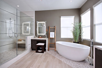 Inspiration for a contemporary master bathroom in Orange County with a freestanding tub, pebble tile floors and beige floor.