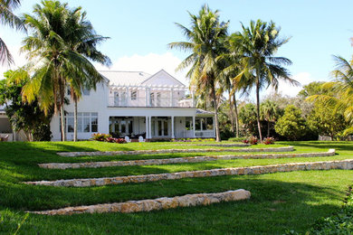 Example of a large island style home design design in Miami