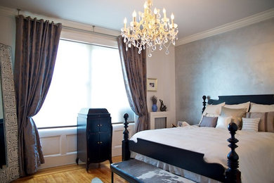 Mid-sized elegant master light wood floor bedroom photo in New York with gray walls and no fireplace
