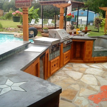 Outdoor kitchen with artistic carved wooden posts