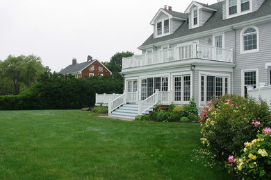 Large elegant gray three-story concrete fiberboard house exterior photo in New York