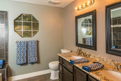Inspiration for a mid-sized transitional master gray tile and porcelain tile ceramic tile and brown floor bathroom remodel in Phoenix with recessed-panel cabinets, dark wood cabinets, a two-piece toilet, beige walls, an undermount sink and granite countertops