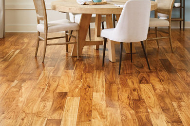Example of a transitional medium tone wood floor dining room design in Raleigh