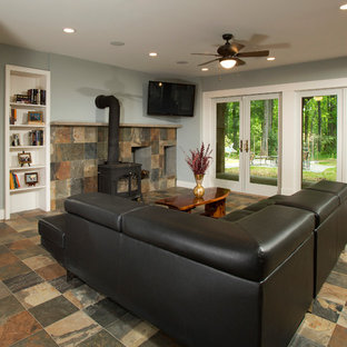 Design ideas for a large classic walk-out basement in DC Metro with grey walls, slate flooring, a wood burning stove and a stone fireplace surround.