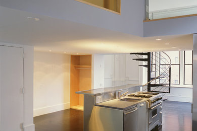 Mid-sized trendy dark wood floor kitchen photo in New York with an undermount sink, stainless steel cabinets, stainless steel countertops and stainless steel appliances