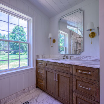 Primary Bathroom with Double Shower and Natural Stone Baseboards