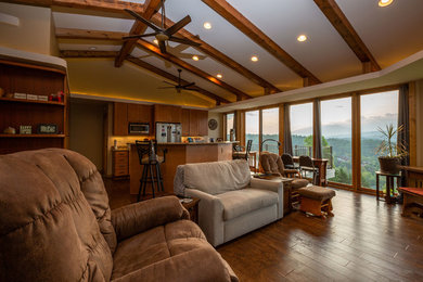 Example of a mid-sized mid-century modern open concept laminate floor and brown floor living room design in Other with beige walls, a standard fireplace and a wood fireplace surround
