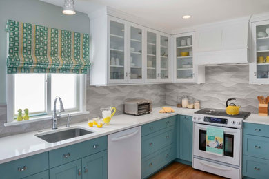 Inspiration for a mid-sized coastal l-shaped medium tone wood floor enclosed kitchen remodel in Philadelphia with an undermount sink, shaker cabinets, quartz countertops, multicolored backsplash, porcelain backsplash, white appliances, no island and blue cabinets
