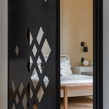 Custom geometric laser-cut steel interior door with diamond pattern revealing be