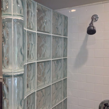 Open shower with a prefabricated curved glass block wall