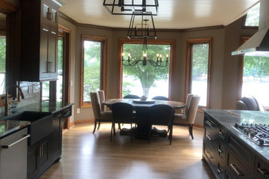 Example of a mid-sized transitional galley eat-in kitchen design in Atlanta with beaded inset cabinets, black cabinets, quartzite countertops, a peninsula and blue countertops