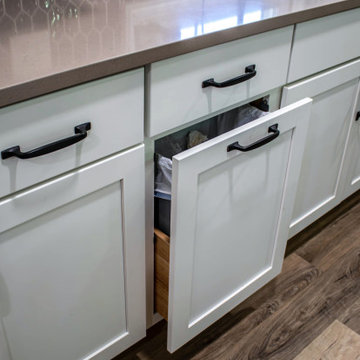 White Kitchen with Blue Tiled Backsplash and Two Tier Island