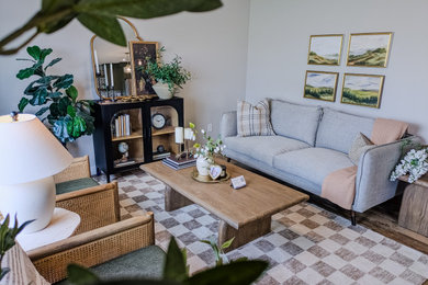 Minimalist vinyl floor and brown floor living room photo in Other