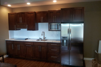 Example of a small trendy galley dark wood floor and brown floor eat-in kitchen design in Seattle with an undermount sink, shaker cabinets, dark wood cabinets, quartz countertops, white backsplash, quartz backsplash, stainless steel appliances, no island and beige countertops