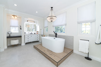 Bathroom - large master white tile single-sink, ceramic tile, gray floor and tray ceiling bathroom idea in Los Angeles with shaker cabinets, white cabinets, quartzite countertops, a freestanding vanity, a one-piece toilet, white walls, an undermount sink, a hinged shower door and white countertops