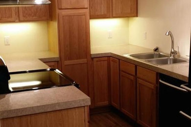 Elegant medium tone wood floor kitchen photo in Other with medium tone wood cabinets and beige backsplash