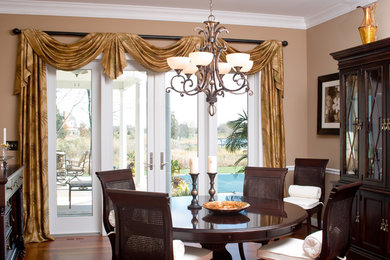 Mid-sized elegant medium tone wood floor enclosed dining room photo in Baltimore with beige walls