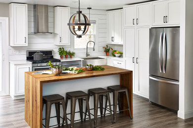 Eat-in kitchen - cottage eat-in kitchen idea in Other with beaded inset cabinets, white cabinets, granite countertops, white backsplash, shiplap backsplash, stainless steel appliances, an island and white countertops