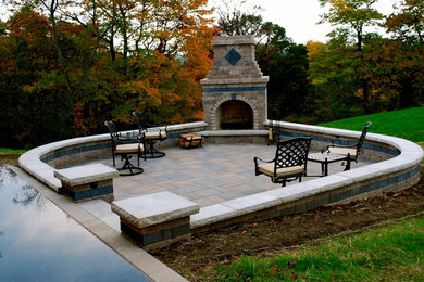 Patio kitchen - large craftsman backyard brick patio kitchen idea in Cleveland with a roof extension