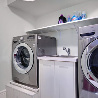 This is an example of a small victorian galley separated utility room in Toronto with a built-in sink, shaker cabinets, white cabinets, laminate countertops, grey walls, ceramic flooring and a side by side washer and dryer.