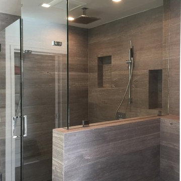 Glass Enclosed Shower With Black Pebble Floor