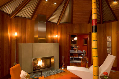 Trendy living room photo in San Diego with a concrete fireplace