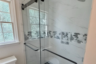 Inspiration for a mid-sized modern 3/4 multicolored tile and porcelain tile porcelain tile, multicolored floor and single-sink bathroom remodel in Baltimore with beaded inset cabinets, white cabinets, a one-piece toilet, white walls, an undermount sink, quartz countertops, black countertops and a freestanding vanity