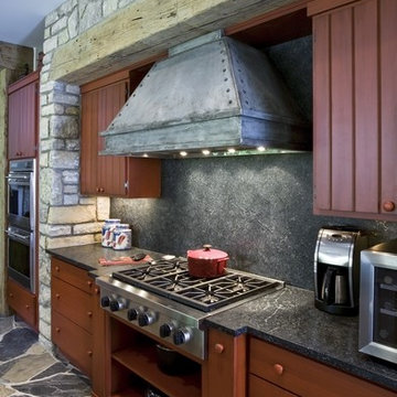 Rustic Red Cabinet Kitchen with Custom Metal Hood and Soapstone Backsplash