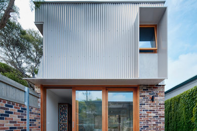 Contemporary two-storey exterior in Sydney with a metal roof.