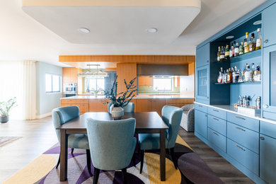 Example of a large trendy brown floor dining room design in Denver with blue walls