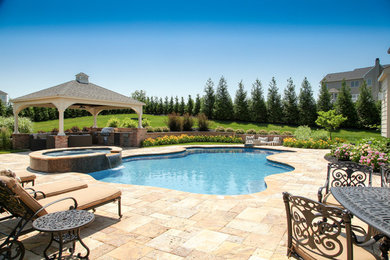 Mid-sized elegant backyard concrete paver and custom-shaped hot tub photo in New York