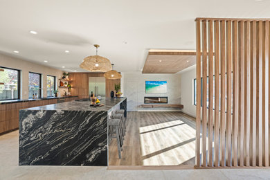 Example of a large 1950s open concept medium tone wood floor, brown floor, wood ceiling and wallpaper family room design in San Francisco with a wood fireplace surround and a wall-mounted tv