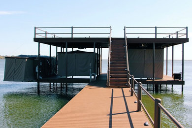 Example of a large backyard patio design in Other