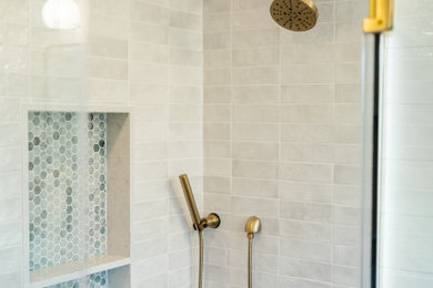 Example of a mid-sized transitional master gray tile and porcelain tile double-sink double shower design in Baltimore with green cabinets, quartz countertops, a hinged shower door, white countertops and a built-in vanity