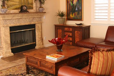 Example of a tuscan living room design in San Francisco with beige walls and a standard fireplace