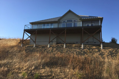 Example of a mid-sized classic gray two-story wood gable roof design in Portland