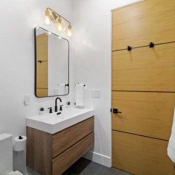 Secondary Bath with Barn Door and Brass Vanity Light